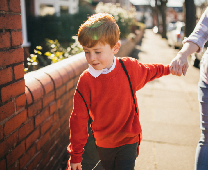 Child walking home from school with parent