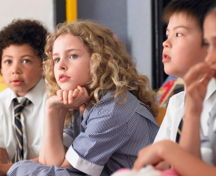 Young girl sitting in class looking a bit distracted