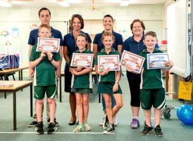 Kathryn Tanner and colleagues from Tradies presenting kids from the Reading for Life program with certificates