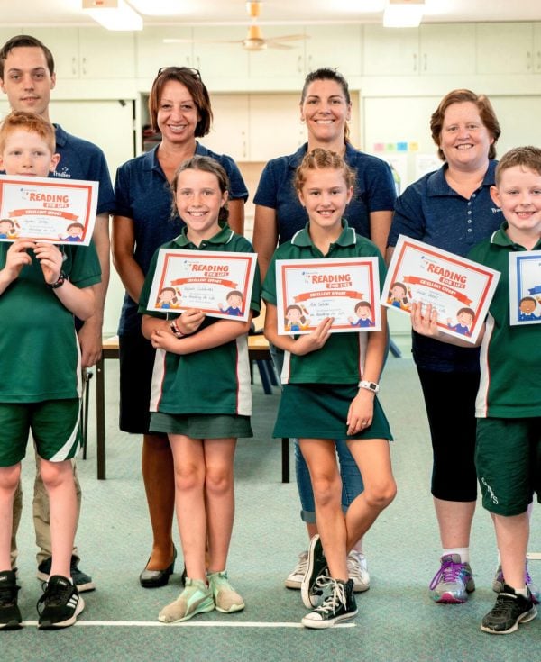 Kathryn Tanner and colleagues from Tradies presenting kids from the Reading for Life program with certificates