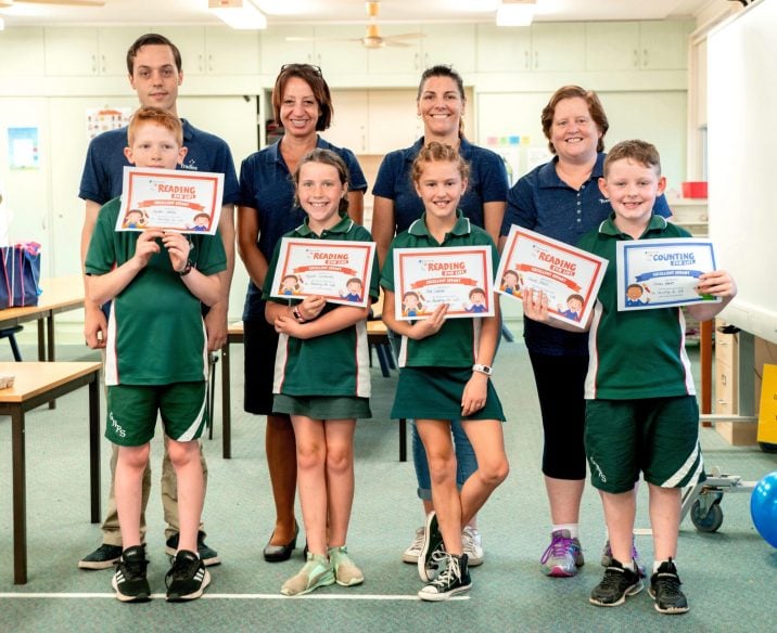 Kathryn Tanner and colleagues from Tradies presenting kids from the Reading for Life program with certificates