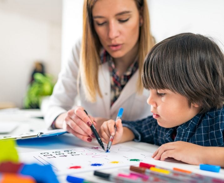 Child having psychology assessment with psychologist