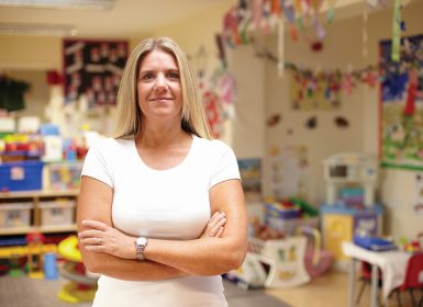 Teacher standing in front of classroom activities