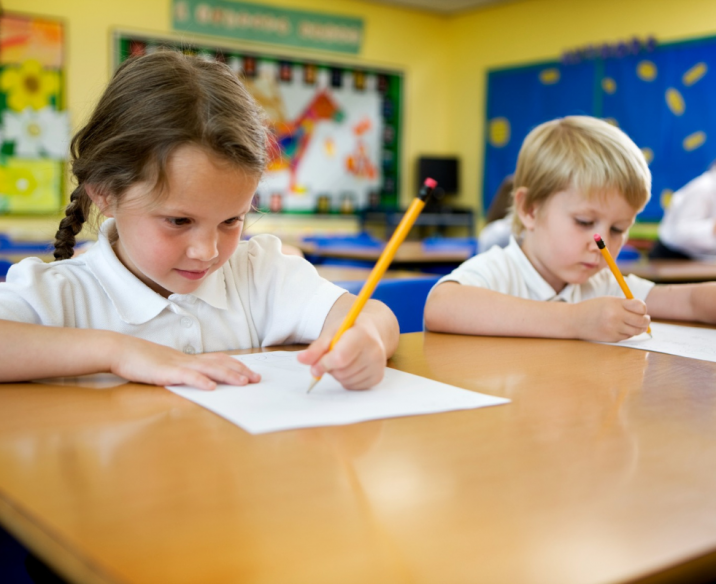 Students sitting at desk focused on completing school work