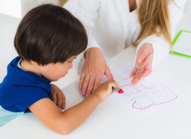 Young child doing logic tests with psychologist