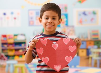 Boy in Preschool holding picture of heart