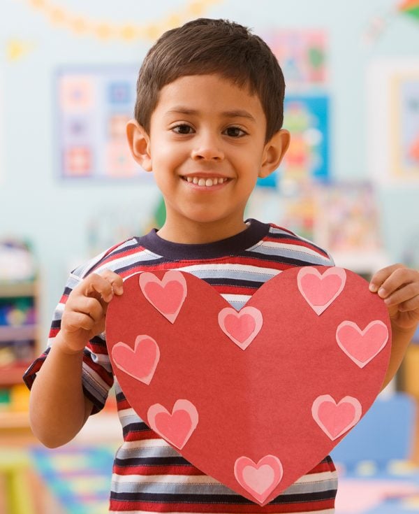 Boy in Preschool holding picture of heart