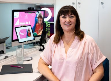 Presenter sitting at laptop to present live webinar