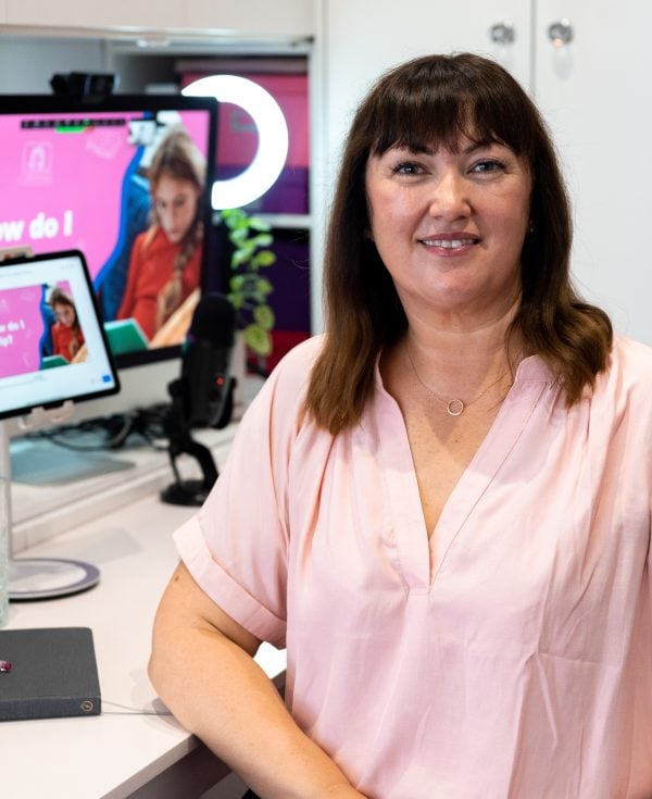 Presenter sitting at laptop to present live webinar