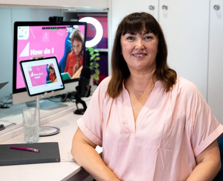 Presenter sitting at laptop to present live webinar