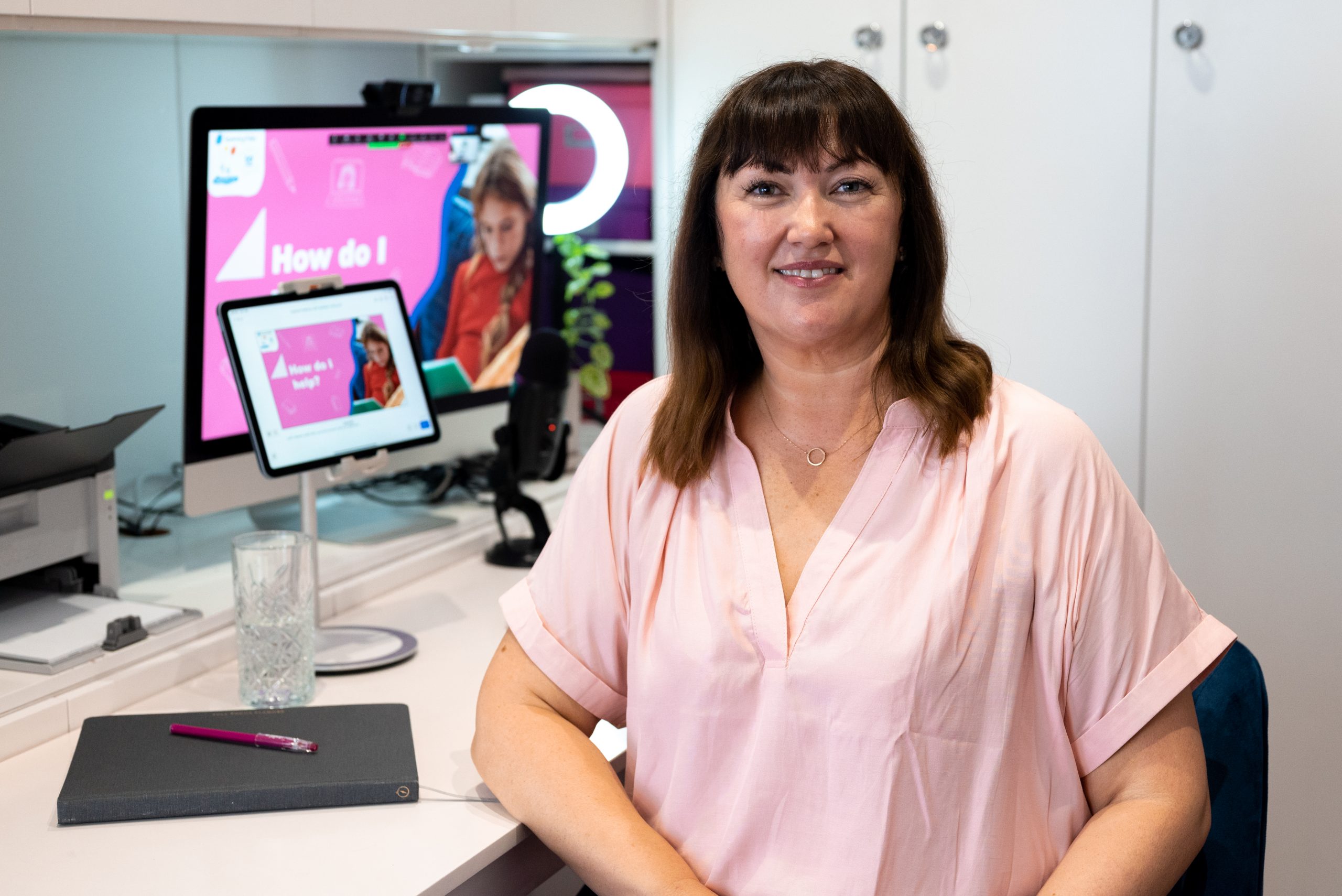 Presenter sitting at laptop to present live webinar