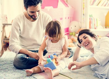 Mum and Dad talking and laughing with young daughter