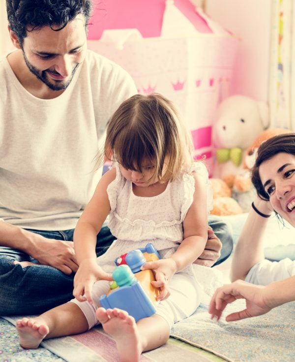 Mum and Dad talking and laughing with young daughter