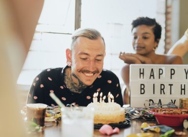 Birthday celebration with male blowing our candles