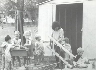 Children in the Learning Links Preschool grounds doing gardening in 1989