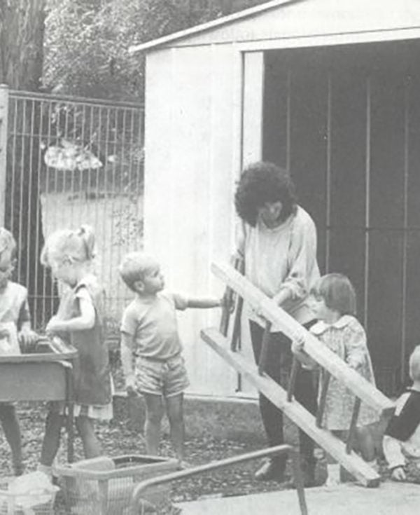 Children in the Learning Links Preschool grounds doing gardening in 1989