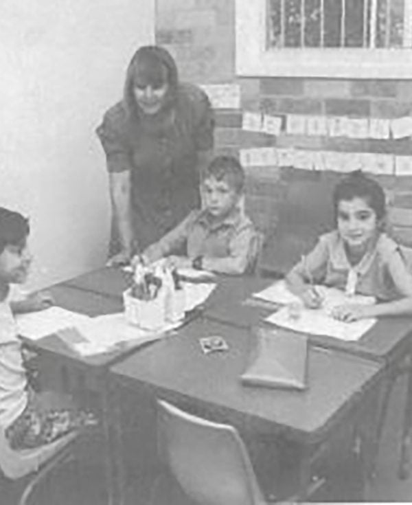 School aged kids sitting at desk participating in Learning Links education program in 1993