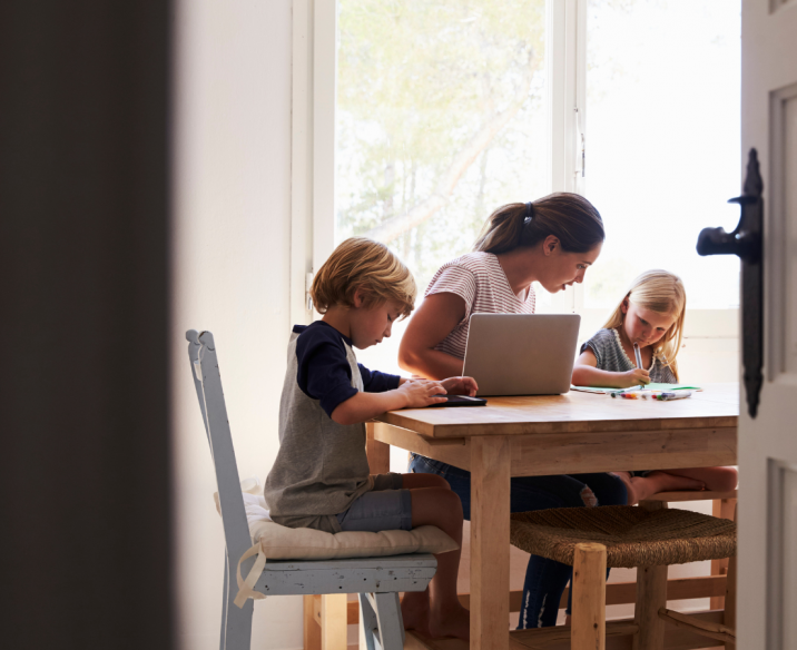 Mum sitting at the table speaking with her children