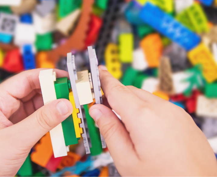 Child's hands putting LEGO bricks together