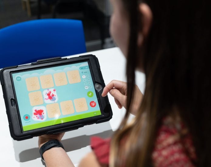 Speech therapist using app on ipad