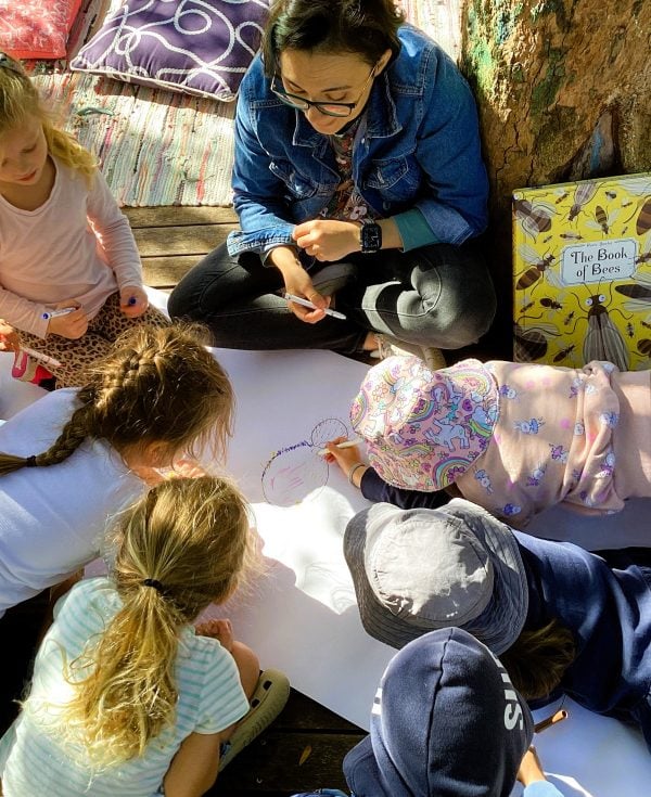 Preschool children in a group working with an educator.
