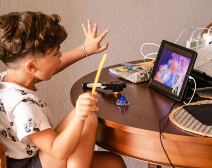 Child playing interactive game on iPad during onling counselling session